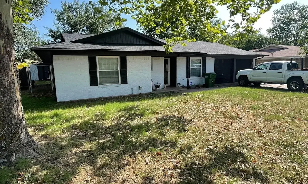 Professional roofing crew working on a residential roof in La Feria
